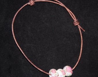 Adjustable brown leather cord bracelet with 3 pink and white floral beads