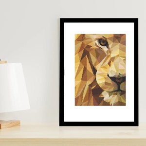 May include: A framed print of a geometric lion's face in shades of brown, yellow, and orange. The lion's eye is visible, and the print is set against a white background.