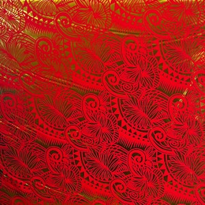 May include: Red and gold fabric with a repeating pattern of stylized flowers and geometric shapes.