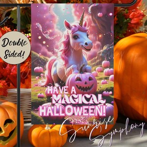 May include: A double-sided garden flag featuring a pink unicorn with a jack-o'-lantern and the text "Have a Magical Halloween!". The flag is set against a backdrop of pink clouds and pumpkins, with a black metal stand.