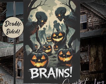 May include: Double-sided Halloween garden flag featuring a spooky scene with glowing-eyed skeletons, jack-o'-lanterns, and the word "BRAINS!" in white. The flag is designed with a dark, eerie color palette, perfect for outdoor Halloween decor.