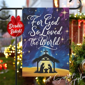 May include: A double-sided garden flag with the text "For God So Loved the World" in white script against a starry night sky. The flag features a nativity scene silhouette and a red bow.