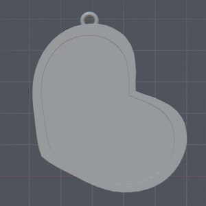 May include: A gray heart-shaped pendant with a loop at the top for hanging.