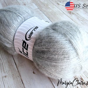 May include: A skein of gray and white yarn with a label that reads "Ice Yarns".