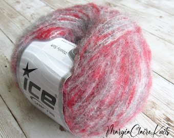 May include: A skein of red and gray yarn with a white label that says "Woolly Soft" and "ICE Yarns".