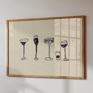 May include: A framed print with black line drawings of different wine glasses and a small tumbler. The artwork is set against a neutral background and framed in light-coloured wood.