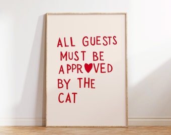 May include: A framed print with the text "ALL GUESTS MUST BE APPROVED BY THE CAT" in red lettering with a red heart in the word "APPROVED".