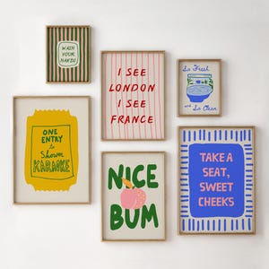 May include: A collection of framed art prints with various text and graphic designs. The prints include phrases like "Wash Your Hands," "I See London I See France," and "Take a Seat, Sweet Cheeks." The color palette includes green, pink, yellow, and blue.