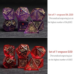 May include: Two sets of engraved polyhedral dice. One set is purple with gold accents, the other is red with gold accents. Each set includes D6 and D20 dice. The text on the dice includes dates and initials.