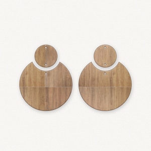 May include: A pair of wooden earrings with a round shape. The earrings are made of two pieces, a smaller circle on top of a larger circle. The wood has a natural brown color and a wood grain pattern.