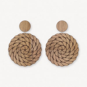 May include: A pair of wooden earrings featuring a braided rope design. Each earring consists of two parts: a round disc and a larger, circular piece with a braided rope pattern.