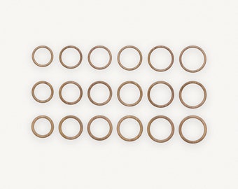 May include: A set of 18 wooden rings, arranged in three rows of six. The rings are all the same size and are a light brown color.