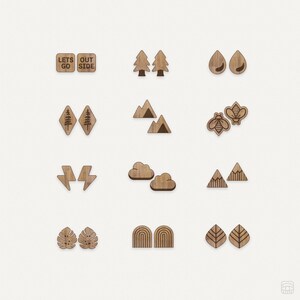 May include: A set of 10 pairs of wooden earrings featuring a variety of nature-inspired designs, such as trees, mountains, clouds, lightning bolts, bees, raindrops, rainbows, and leaves. The earrings are all crafted from natural wood and have a rustic, minimalist style.