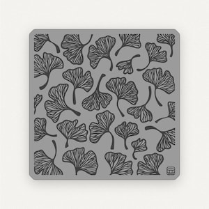 May include: A gray nail stamping plate with a repeating pattern of black ginkgo leaves.
