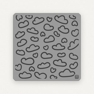May include: A gray silicone stamping plate with a repeating pattern of clouds and hearts. The plate is designed for nail art and is made of a flexible material.