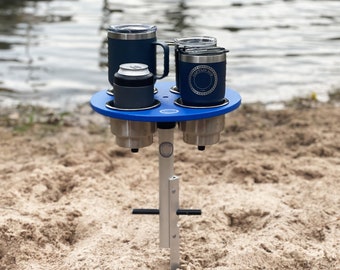 Beach table with stainless steel cup holders and interchangeable design, Marine-grade beach table. SandBar™ Click & Play system.
