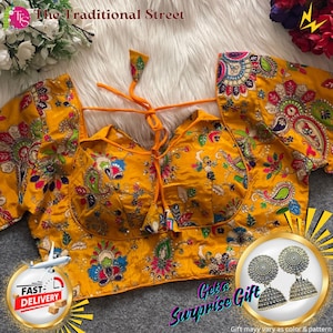 Pode incluir: Uma blusa amarela com bordados florais e paisley intrincados. A blusa tem uma frente amarrada e é adornada com bordados coloridos. A imagem também inclui um par de brincos de prata e o texto "Get a Surprise Gift".