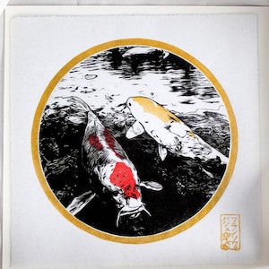 May include: A black and white illustration of two koi fish swimming in a pond. The fish are surrounded by a gold circle and the image is signed in Japanese.