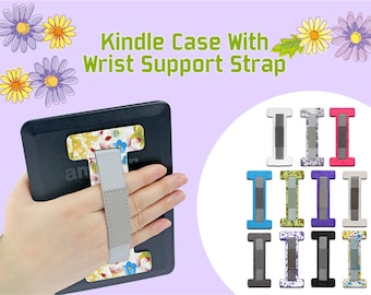 May include: A black Kindle case with a floral pattern and a gray wrist strap. The case has a built-in stand and a strap to hold the Kindle securely. The case is available in a variety of colors and patterns.