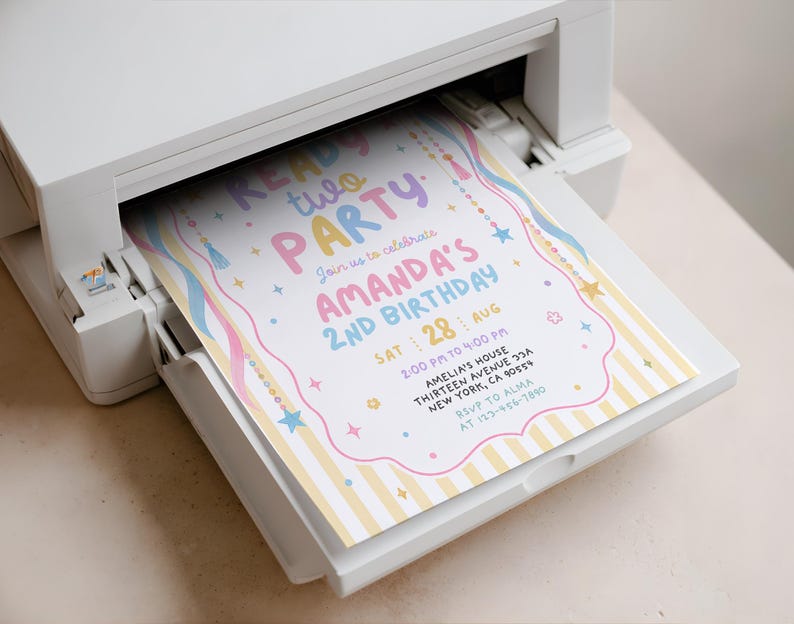 May include: A white printer outputting a birthday invitation with yellow stripes, pink and blue text reading READY TWO PARTY AMANDA'S 2ND BIRTHDAY, and colourful star and tassel graphics. The invitation includes event details like date, time, and location.