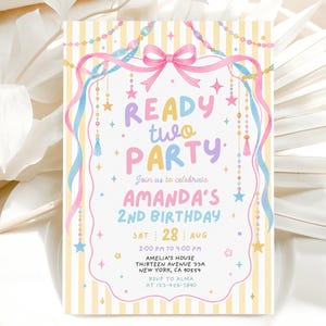 May include: A rectangular birthday invitation card featuring a yellow and white striped background with a pink bow, blue and pink ribbons, and hanging star and bead garlands. The text reads READY TWO PARTY, Join us to celebrate AMANDA'S 2ND BIRTHDAY, SAT 28 AUG, 2:00 PM TO 4:00 PM, AMELIA'S HOUSE THIRTEEN AVENUE 32A NEW YORK, CA 90554, RSVP TO ALMA AT 123-456-7890.