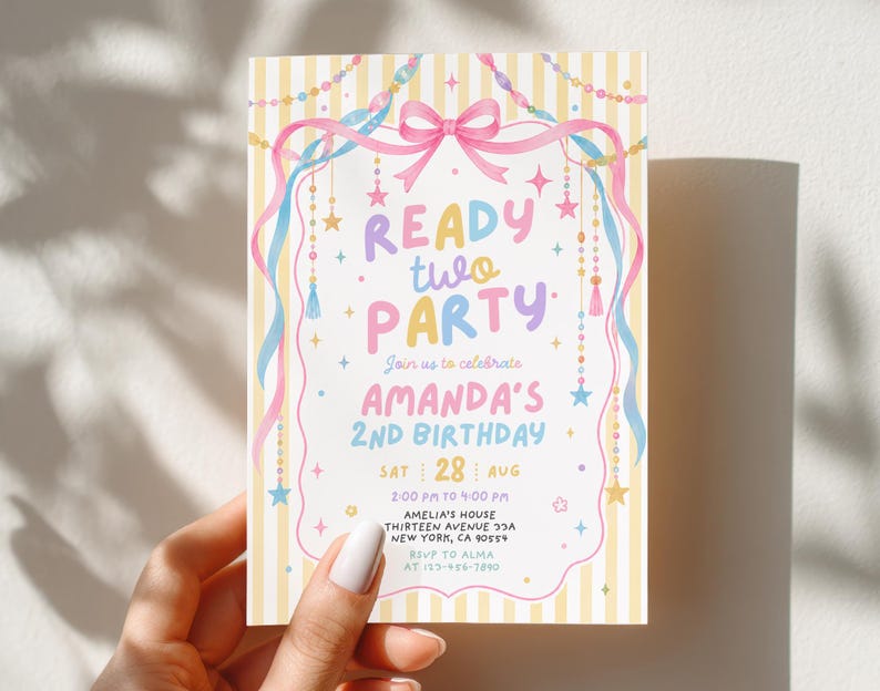 May include: A rectangular birthday invitation card featuring a yellow and white striped background with a pink bow, blue and pink ribbons, and hanging star and bead decorations. The text reads READY TWO PARTY, AMANDA'S 2ND BIRTHDAY, SAT 28 AUG, 2:00 PM TO 4:00 PM, AMELIA'S HOUSE, THIRTEEN AVENUE 33A, NEW YORK, CA 90554, RSVP TO ALMA, 123-456-7890.