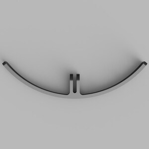 May include: A curved, matte gray metal component featuring a central mounting bracket with two parallel vertical tabs. The object has a smooth, arc-shaped profile with a consistent thickness, designed for mechanical attachment or structural support.
