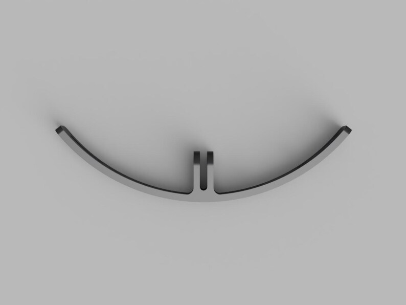 May include: A curved, matte gray metal component featuring a central mounting bracket with two parallel vertical tabs. The object has a smooth, arc-shaped profile with a consistent thickness, designed for mechanical attachment or structural support.