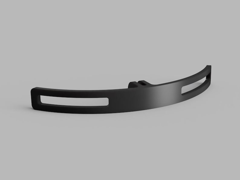 May include: A matte black curved bracket featuring a central mounting point and two elongated horizontal rectangular cutouts on either side. The component has a smooth finish and a symmetrical design with a solid center section and open ends.