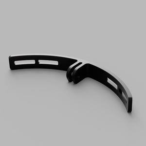 May include: A black, curved mounting bracket featuring a central hinge connector with two parallel tabs and elongated rectangular slots along each arm. The component has a smooth, matte finish and a semi-circular design for attachment purposes.