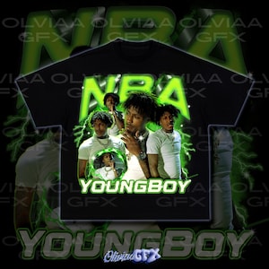 May include: Black t-shirt featuring a graphic design with the text "NBA" in neon green, along with images of a person. The word "YOUNGBOY" is printed below the images in white. The design includes lightning bolt accents and the text "OLIVIAA GFX".