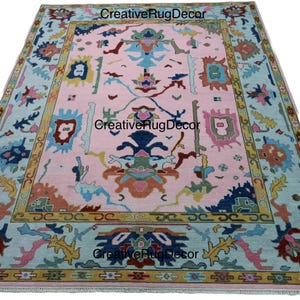 Hand-Knotted Soft Pink Wool Oushak Rug: Turkish Floral Design
