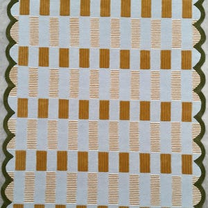 May include: A light blue and mustard yellow checkered rug with a scalloped border. The rug has a subtle texture and a modern design.