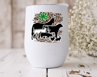 May include: White stainless steel tumbler with a green 4-H clover and black silhouettes of farm animals on a brown leopard print background.