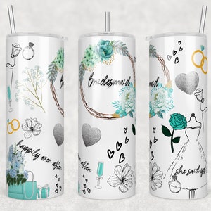 May include: White tumbler with a stainless steel straw, featuring a floral wreath design with the word "Bridesmaid". The tumbler is decorated with hearts, flowers, and the phrases "happily ever after" and "she said yes".