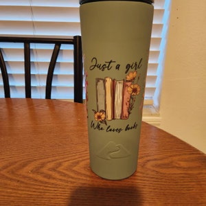 a cup with a book on it sitting on a table