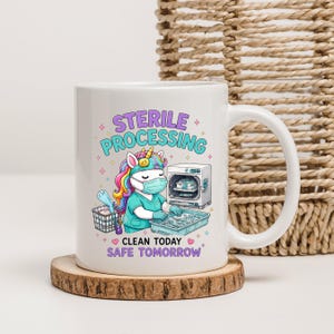 May include: A white ceramic mug featuring a colorful unicorn wearing a surgical mask and scrubs, working with medical instruments. The text reads STERILE PROCESSING above and CLEAN TODAY SAFE TOMORROW below, surrounded by small stars and hearts.