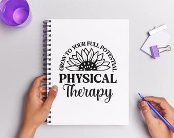 May include: A white spiral-bound notebook with the words "GROW TO YOUR FULL POTENTIAL PHYSICAL Therapy" in black. A purple cup, a purple binder clip, and a blue pen are also visible.