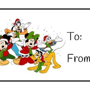 May include: A Christmas gift tag featuring Mickey Mouse, Minnie Mouse, Donald Duck, Goofy, and Pluto dressed in festive attire. The tag has the words "To:" and "From:" printed on it.