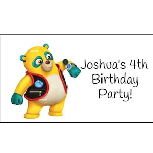 May include: A yellow bear wearing a black vest with a blue paw print on it. The bear is holding a microphone and has a blue watch on its wrist. The text "Joshva's 4th Birthday Party!" is written in black on a white background.