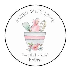May include: A round sticker with a black border featuring a watercolor illustration. The design includes a mixing bowl with baking tools and flowers, and the text "Baked with Love" and "From the kitchen of Kathy".