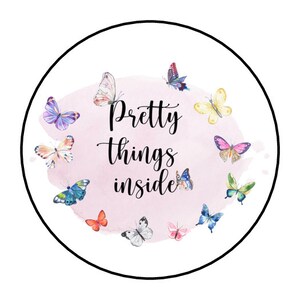 May include: A pink circle with a watercolor background and the text "Pretty things inside".  The circle is surrounded by a variety of colorful butterflies.