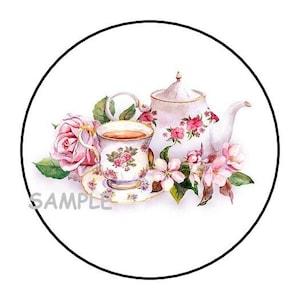 May include: A white teacup and teapot with pink floral designs, surrounded by pink roses and white blossoms. The teacup is filled with tea and the teapot has a lid.