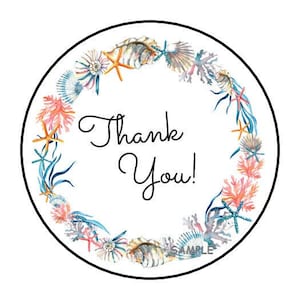 May include: Round sticker with a wreath of seashells, coral, and starfish. The wreath is in shades of pink, blue, orange, and white. The text "Thank You!" is in the center of the sticker.