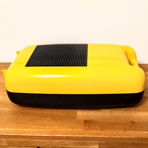 May include: A yellow and black portable cassette player with a black grill on the top.