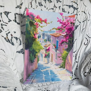 May include: Watercolor painting of a narrow street in a European town. The buildings are pink with blue doors and windows, and the street is paved with blue stones. Bougainvillea flowers in shades of pink and purple cascade over the buildings.