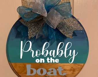 Probably on the boat door hanger. Nautical boat door decor. Coastal blue year-round wreath with large bow. Boating gift.
