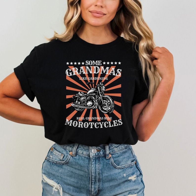 May include: Black t-shirt with a graphic of a motorcycle and the text "Some Grandmas Like Gardening Real Grandmas Ride Motorcycles".