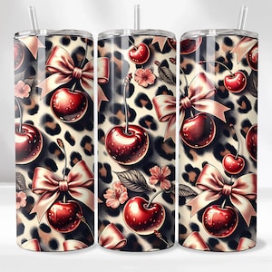 May include: Three stainless steel tumblers with a cherry and bow design. The design features red cherries, pink bows, and pink flowers on a leopard print background. Each tumbler has a clear straw.