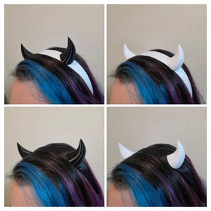 May include: Four headbands with devil horns are shown. Two have black horns, and two have white horns. The horns are attached to a white or black headband. The hair in the image is blue, purple, and black.